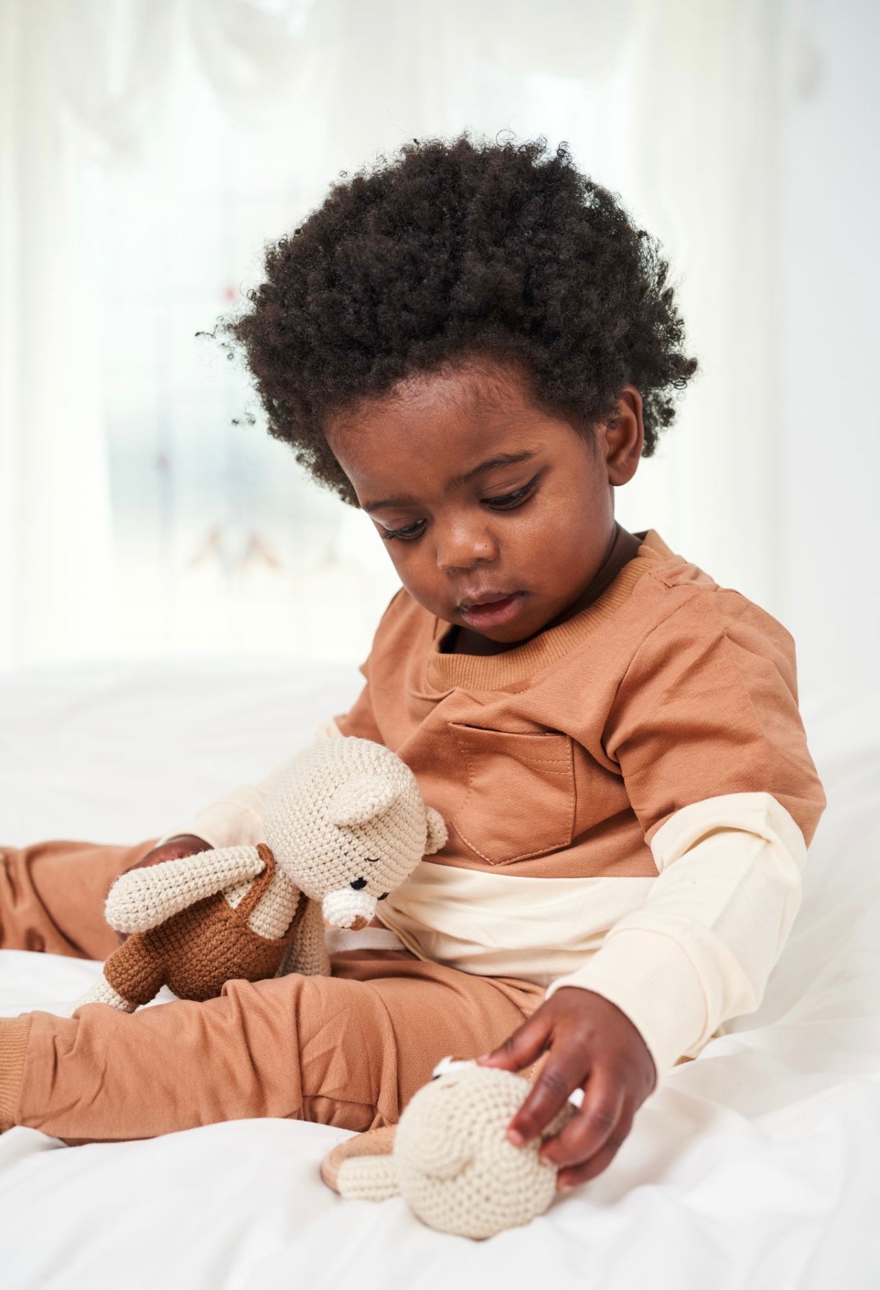 Handmade knitted baby bear doll by Knitted Friends