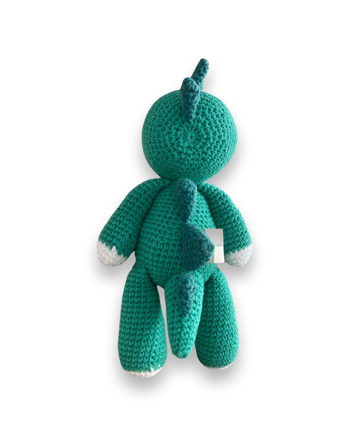 Rear view of a handmade teal crochet dinosaur plush toy with dark teal spikes down its back and white-tipped feet, by Knitted Friends