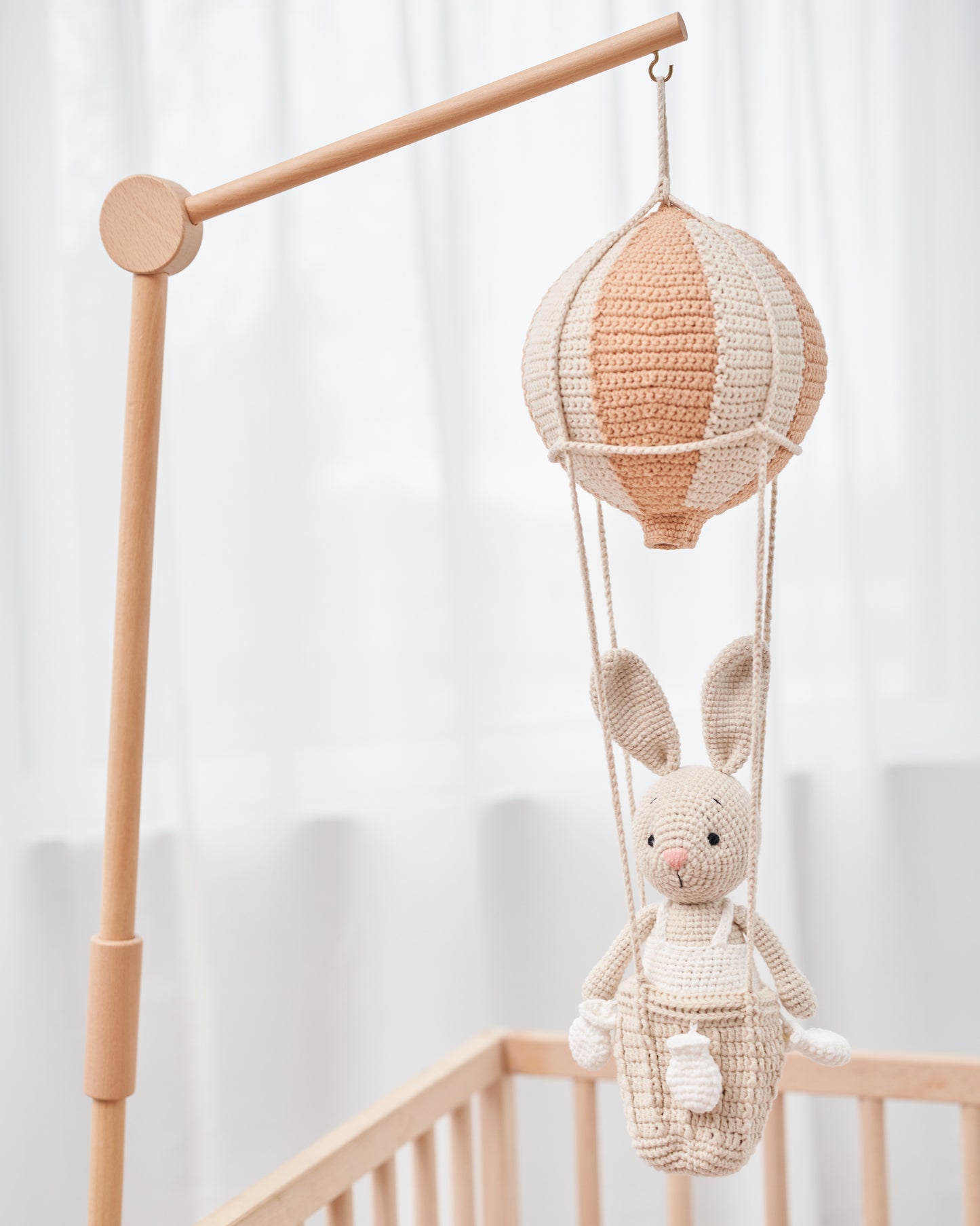 Handmade crochet bunny hanging in a hot air balloon nursery mobile by Knitted Friends