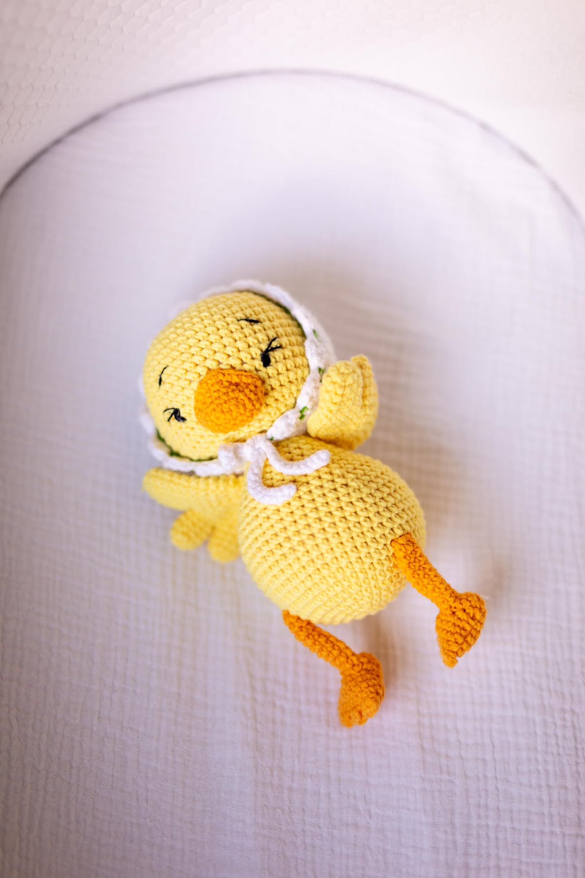 Handmade yellow crochet baby duck doll in organic cotton by Knitted Friends