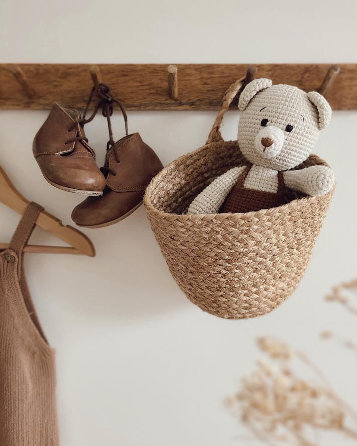 Handmade baby bear doll by Knitted Friends inside a basket