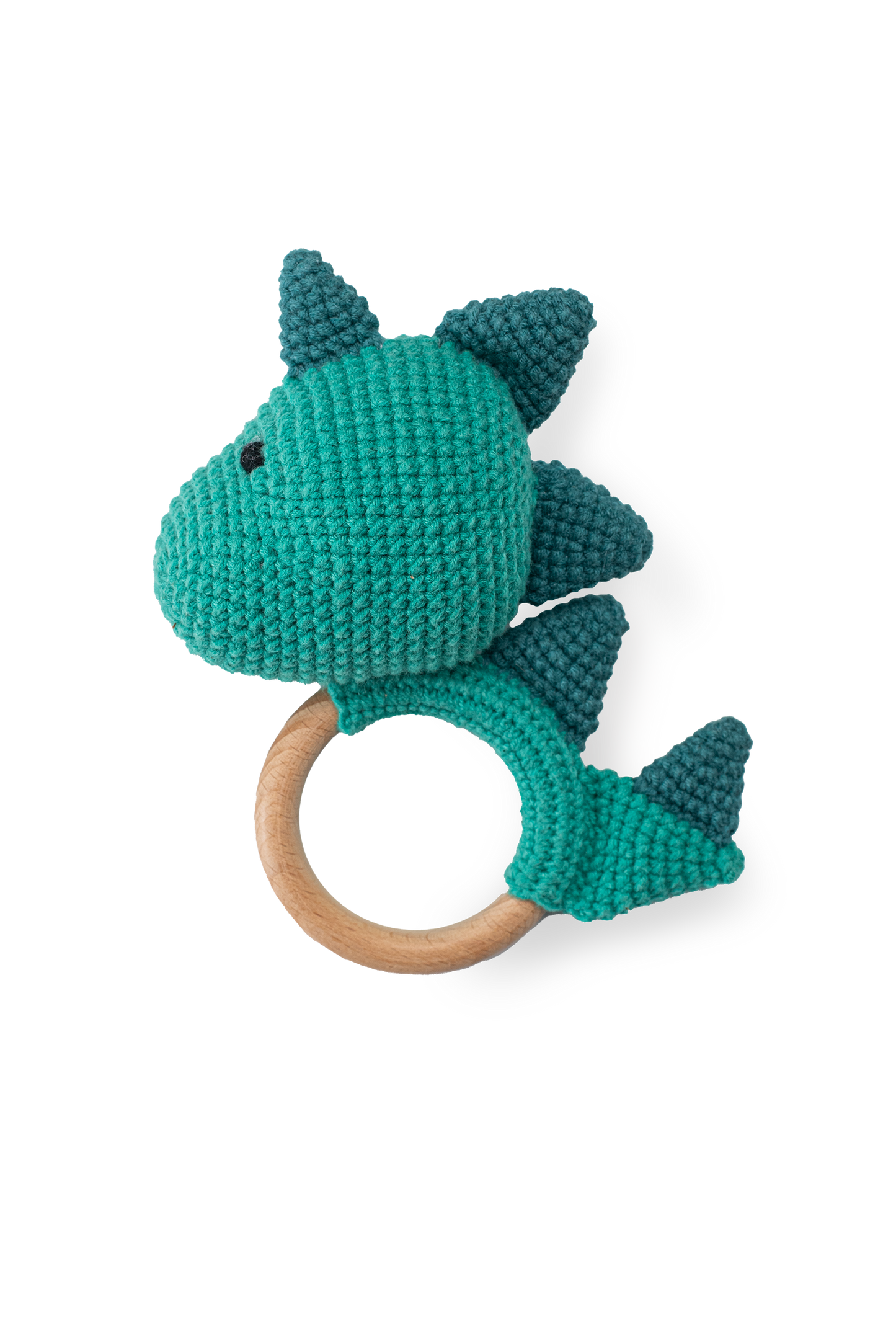 Handmade teal crochet dinosaur teether toy with smooth natural wooden ring by Knitted Friends, featuring detailed dark teal scales, isolated on a clean black background.