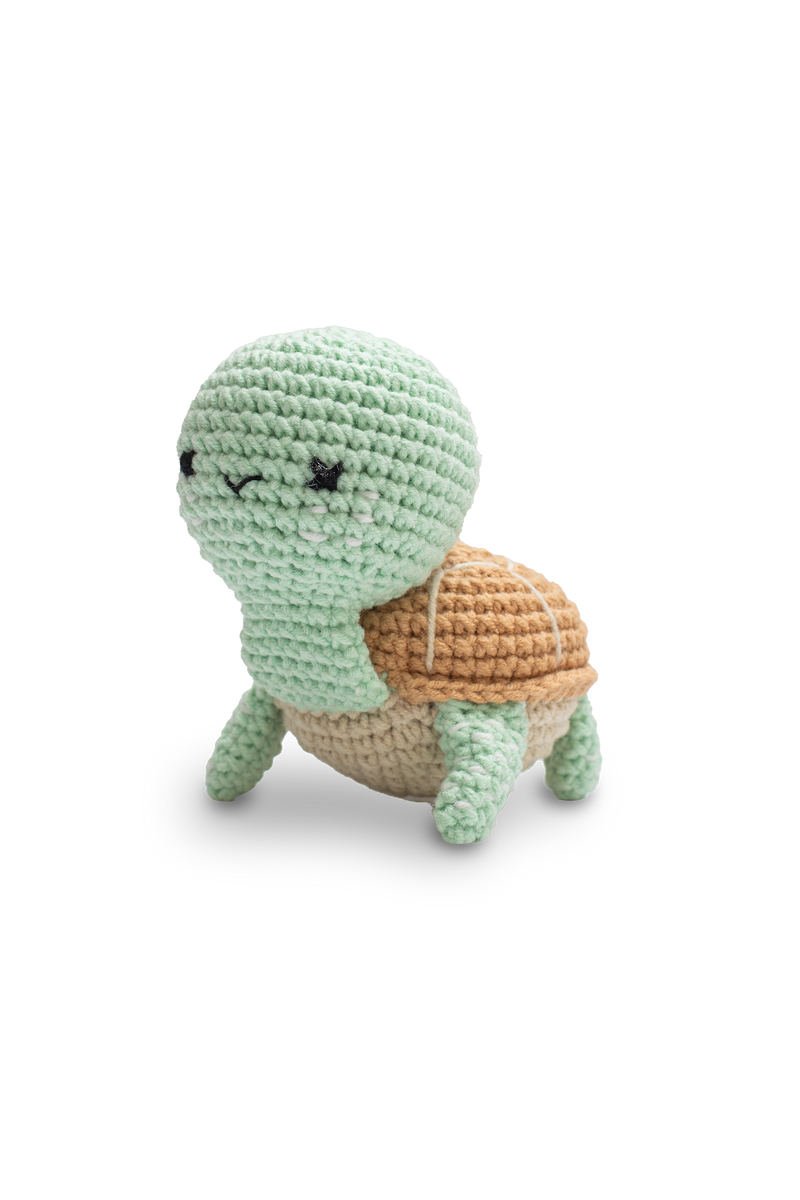 Handmade crocheted turtle toy in soft mint green with a brown shell by Knitted Firneds