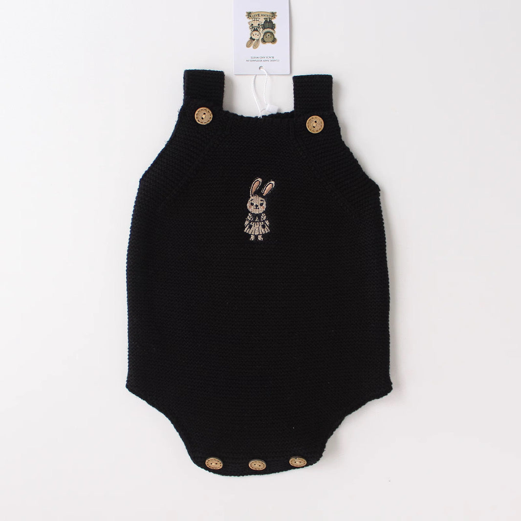 Black knit baby onesie with bunny design in organic cotton by Knitted Friends