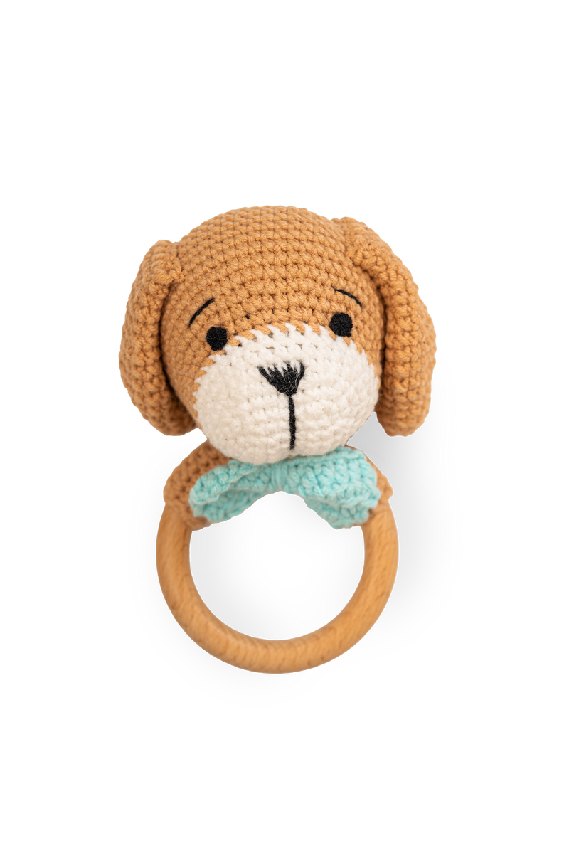 Handmade crocheted puppy rattle toy with wooden ring handle and blue collar detail by Knitted Friends