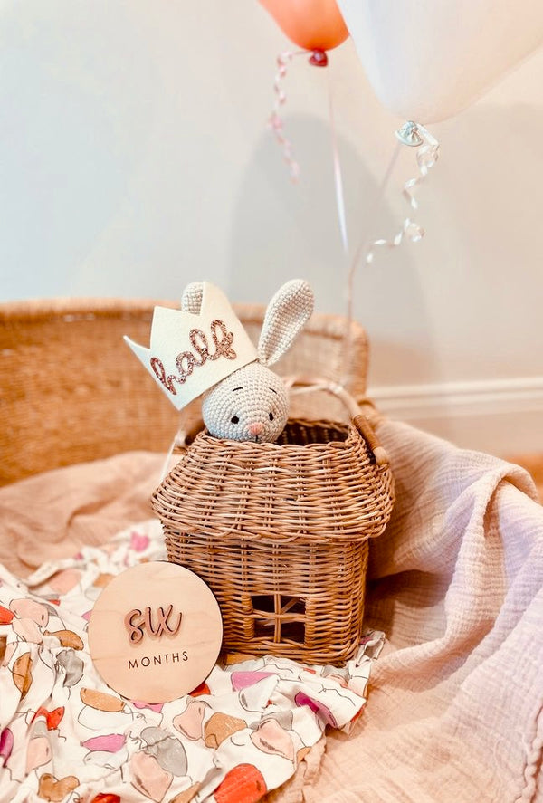 Bunny Stuffed Animal in a basket with nursery decor in the background