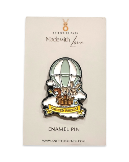 Knitted Friends enamel pin featuring a hot air balloon with animal characters, displayed on branded “Made with Love” card packaging