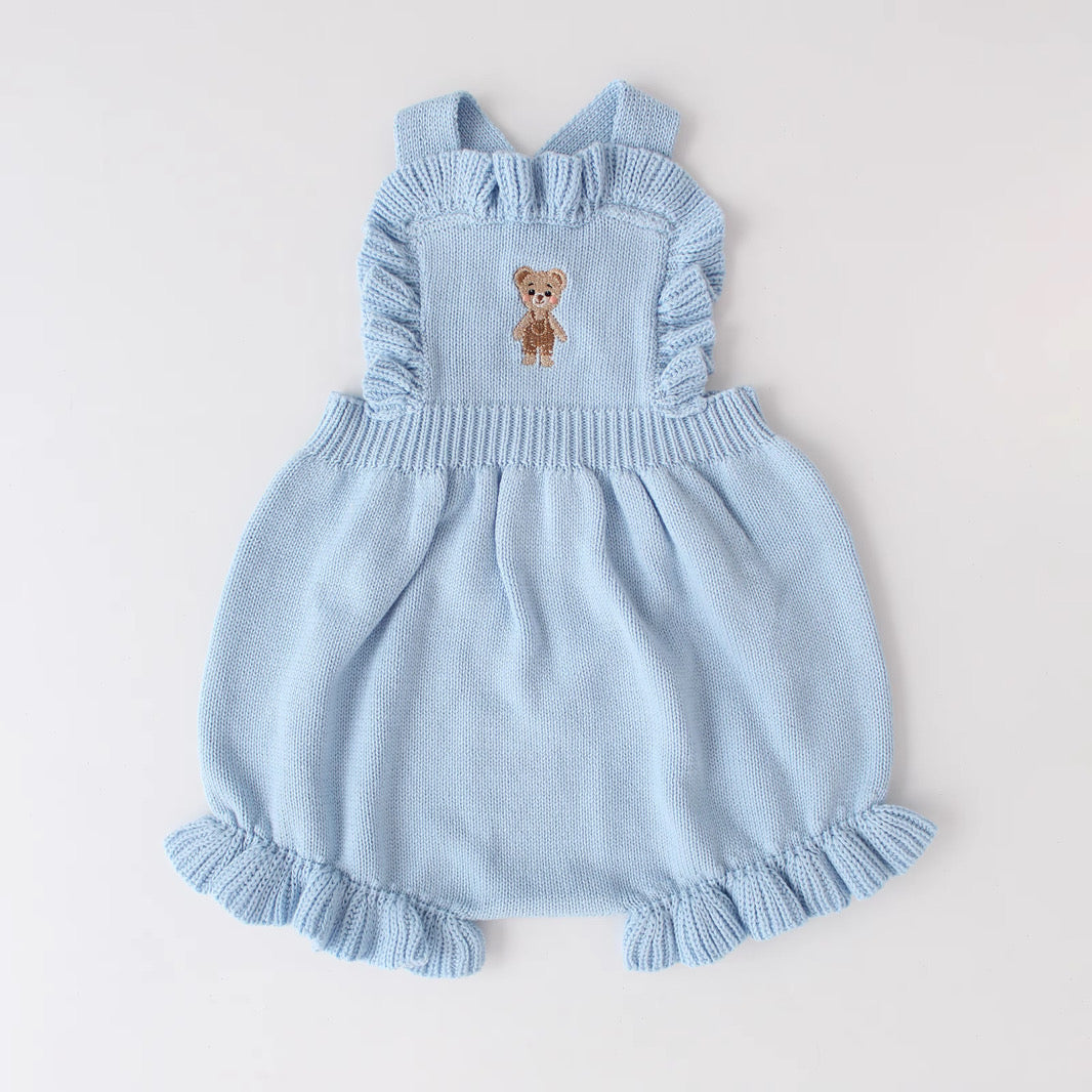 Knitted Friends light blue baby overalls with embroidered bear and ruffle details, displayed on a neutral background