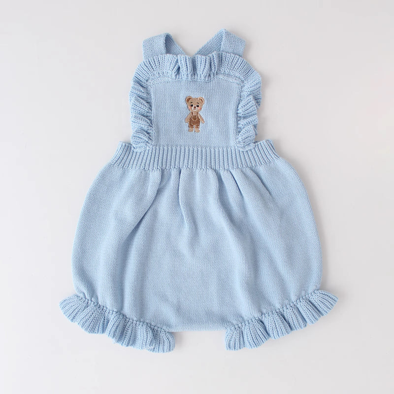 Knitted Friends light blue baby overalls with embroidered bear and ruffle details, displayed on a neutral background