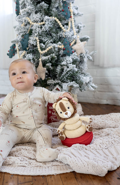 Baby playing with a handmade crochet lion stackable toy crafted by Knitted Friends