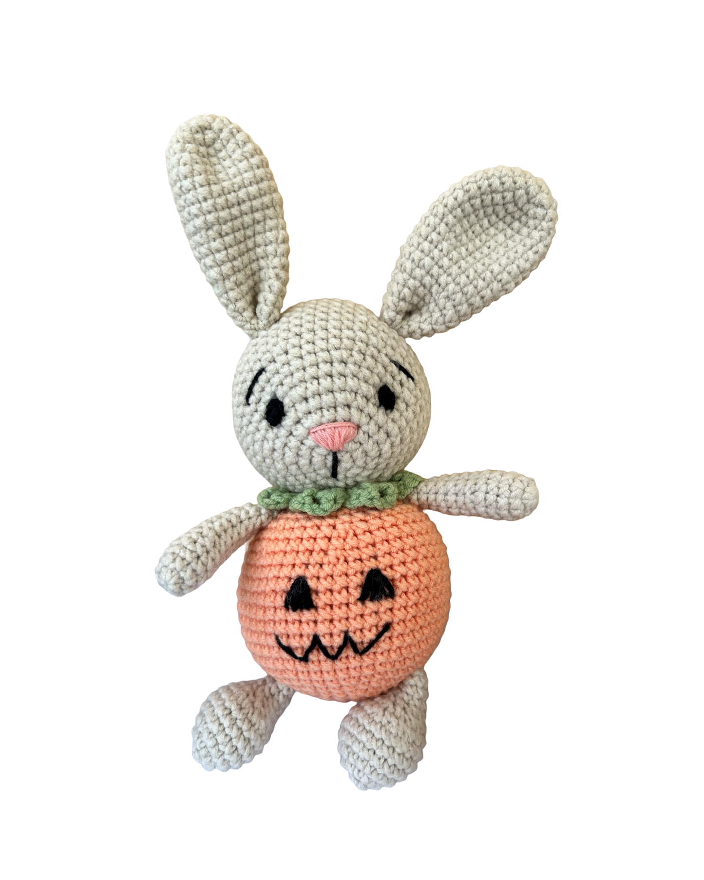 Knitted Friends pumpkin bunny doll with crochet bunny ears and pumpkin body, displayed on a black background