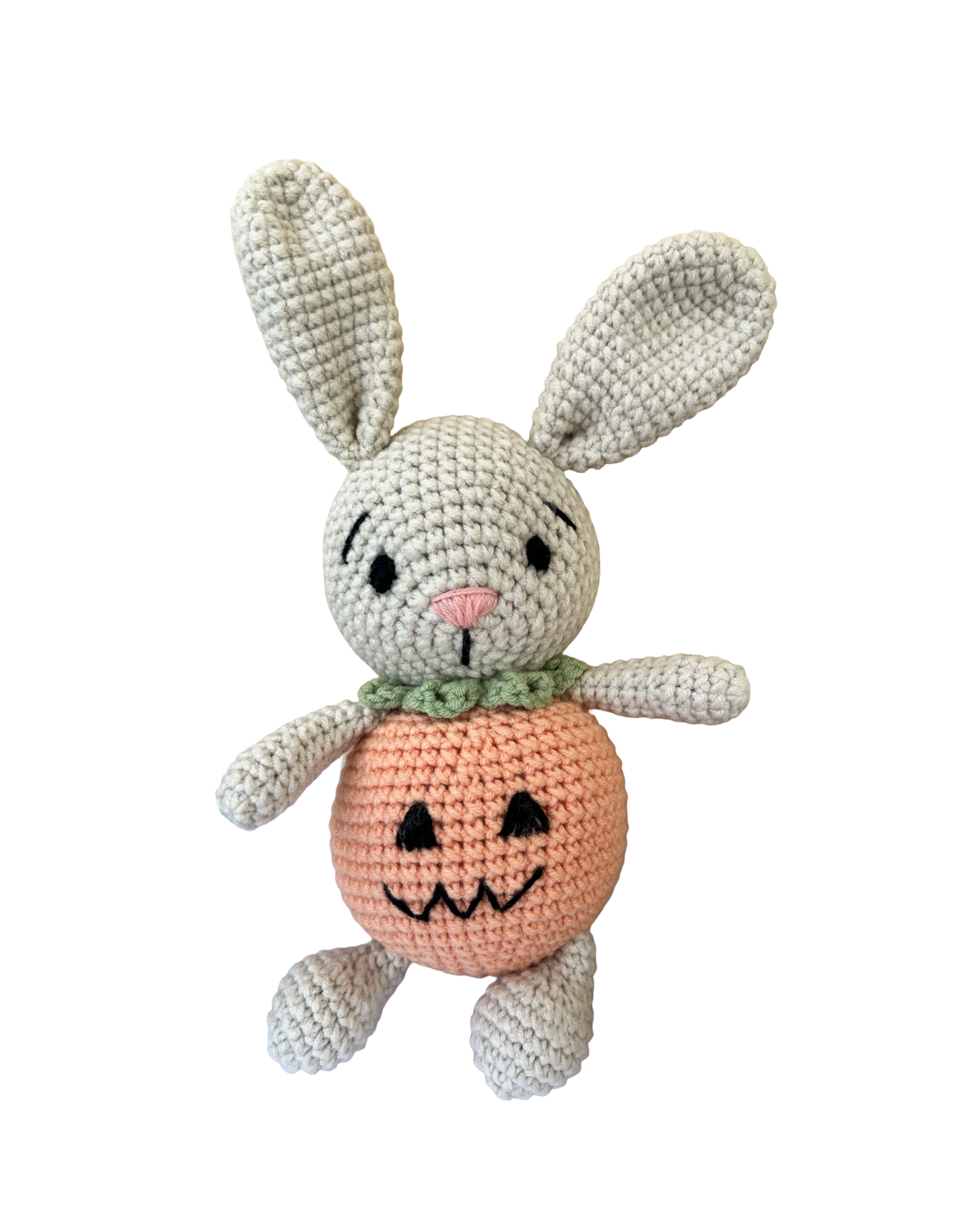 Knitted Friends pumpkin bunny doll with crochet bunny ears and pumpkin body, displayed on a black background