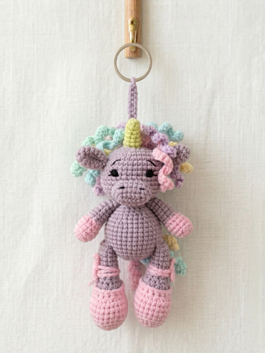 Handmade crochet unicorn bag charm in pastel colours made by Knitted Friends